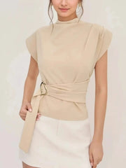 Close-up of the mock neck and belted waist detail