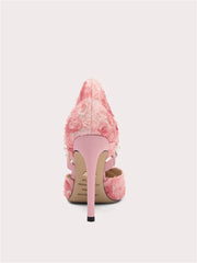 Pink high-heeled shoes with floral design on a white background
