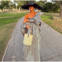 Strapless stripe maxi dress worn in a park setting