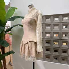 Apricot lace high neck mini dress with sheer long sleeves and structured bodice, side view