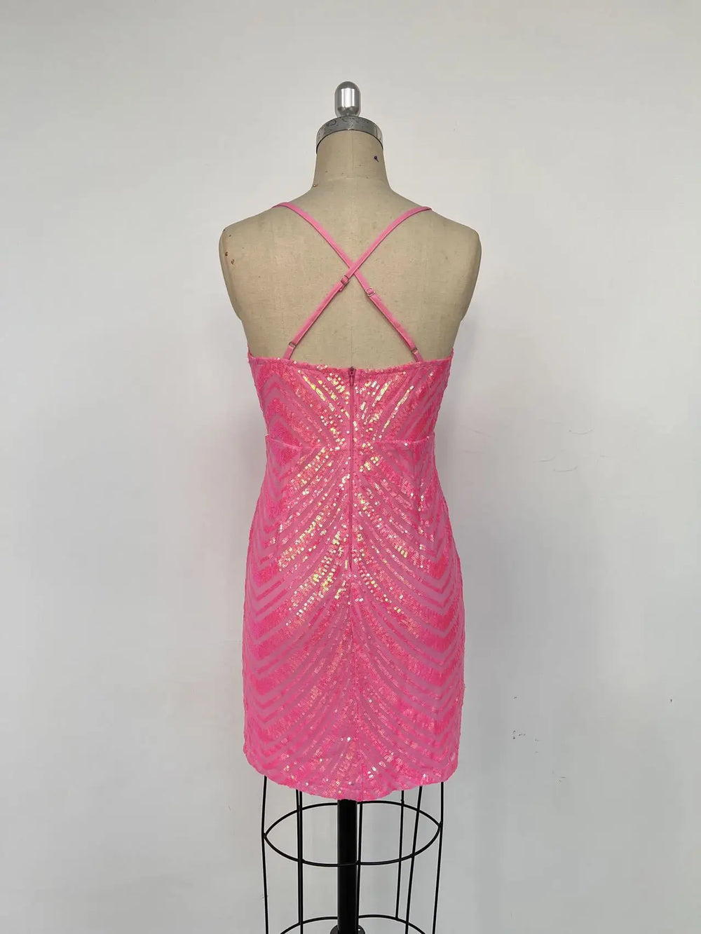 Pink sequin dress on a mannequin against a white background