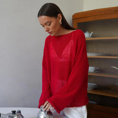 A woman wearing a stylish Red transparent knit sweater with long sleeves, perfect for fall layering. Golden Atelier 4