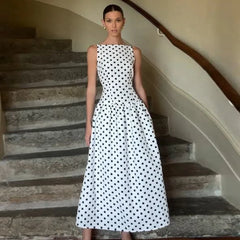 Woman in a polka dot dress standing on a staircase