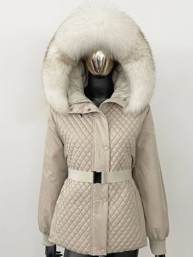 Beige quilted jacket with large fur hood on a mannequin against a white background
