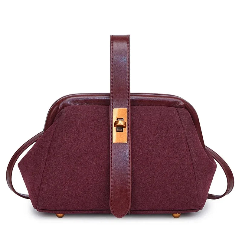Maroon handbag with a gold clasp on a white background