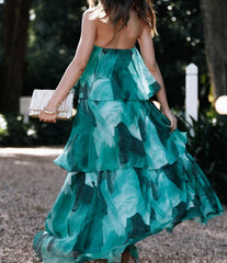Woman in a green floral dress walking outdoors