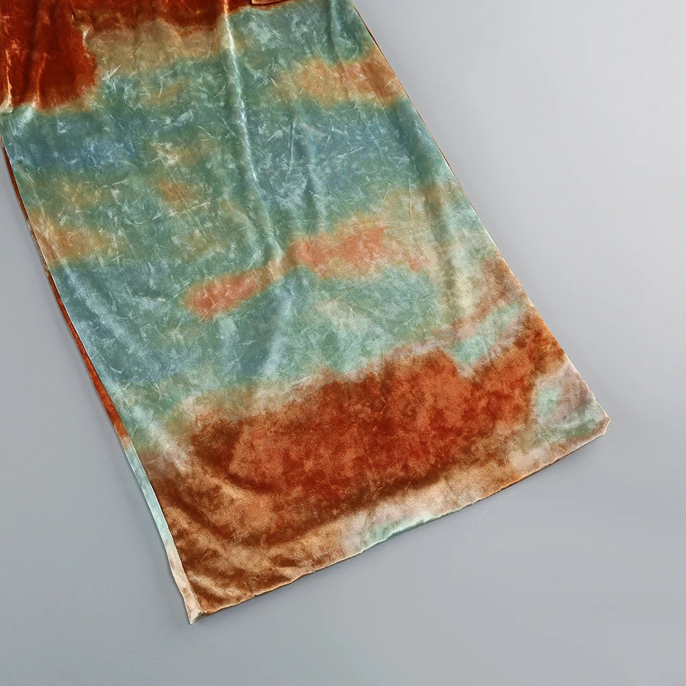Tie-dye fabric with orange and green patterns on a gray background
