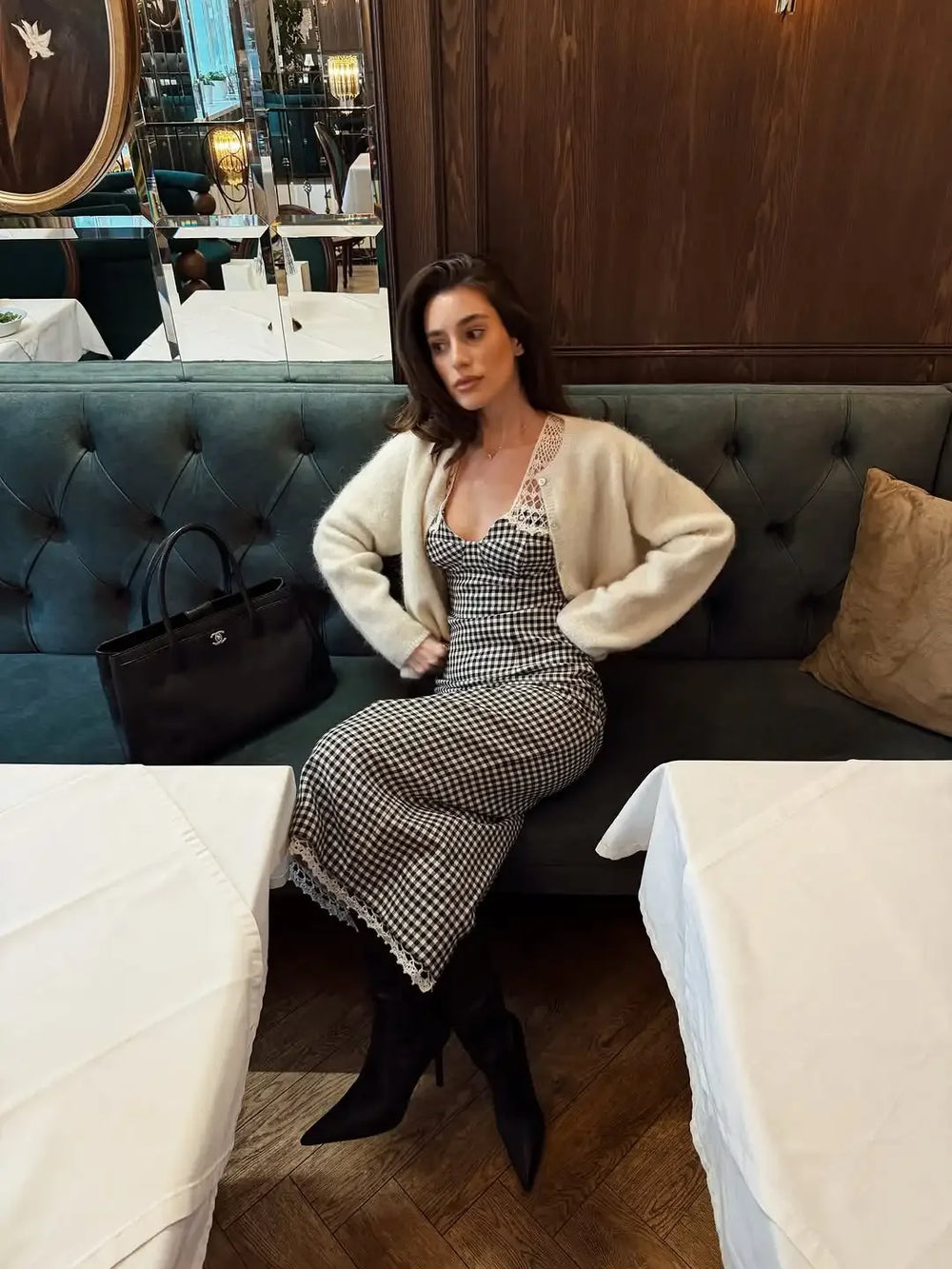 Woman sitting on a couch in a restaurant setting