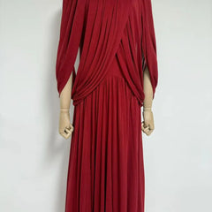 Red pleated dress on a mannequin against a white background