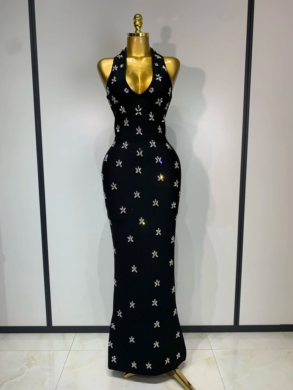Halter neck sleeveless ankle-length knit bodycon gown with scattered diamond embellishments, front view.