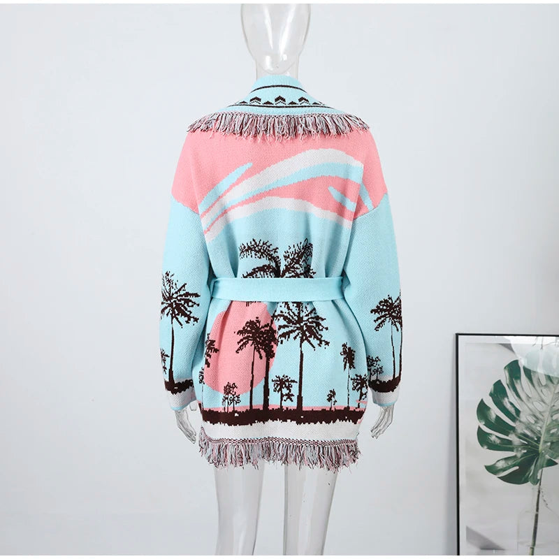 Mannequin wearing a colorful cardigan with palm tree pattern on a white background