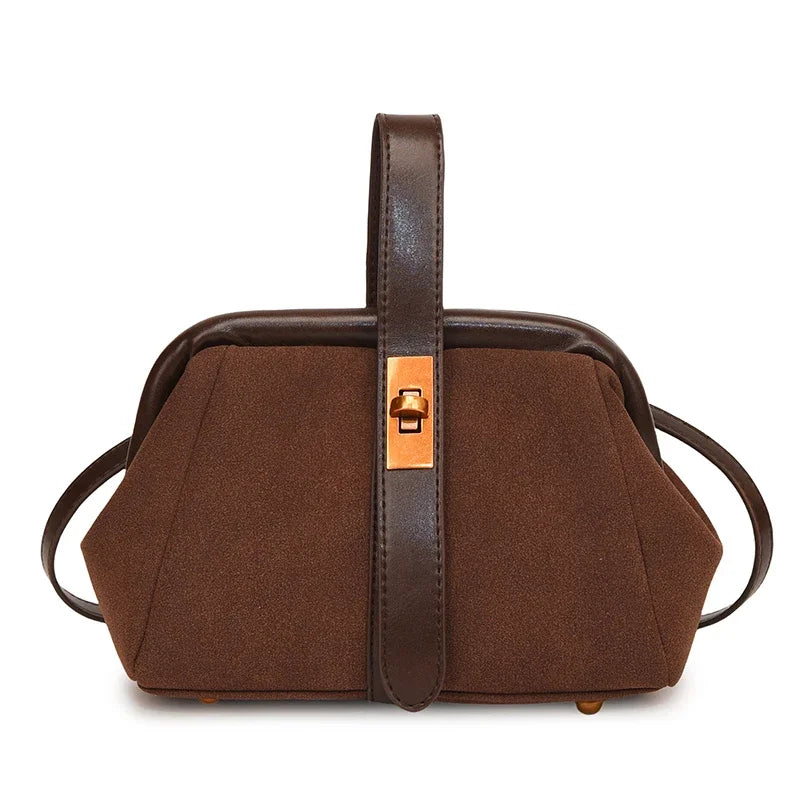 Brown handbag with a strap on a white background