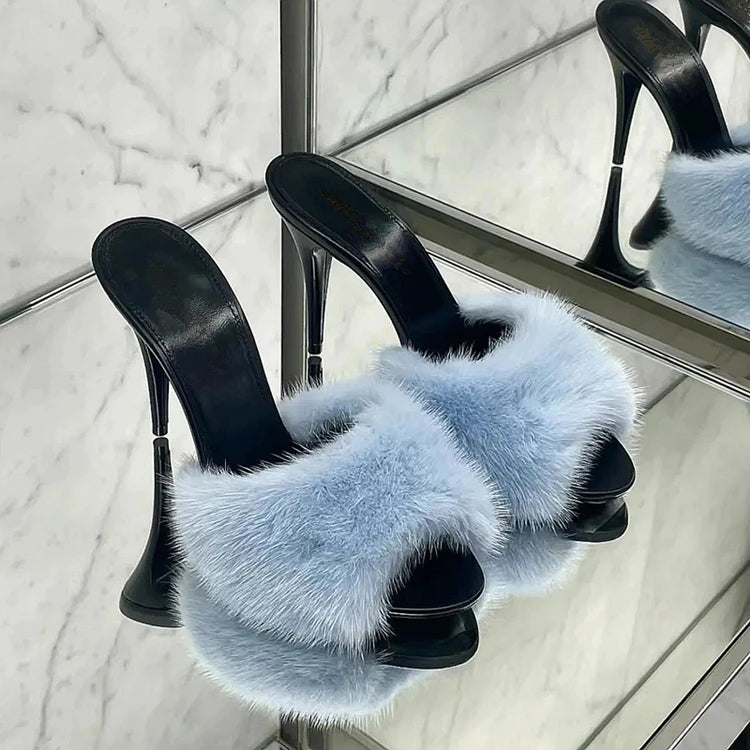Light blue fur slide heels with black sole and stiletto heel