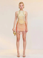 Woman wearing a colorful dress with a gradient effect on a plain background