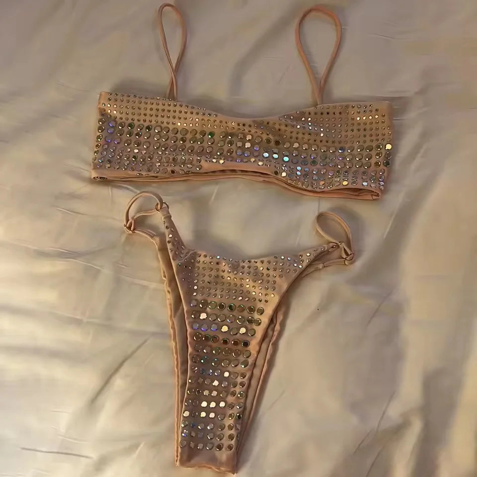 Embellished bikini set laid flat on a white surface.