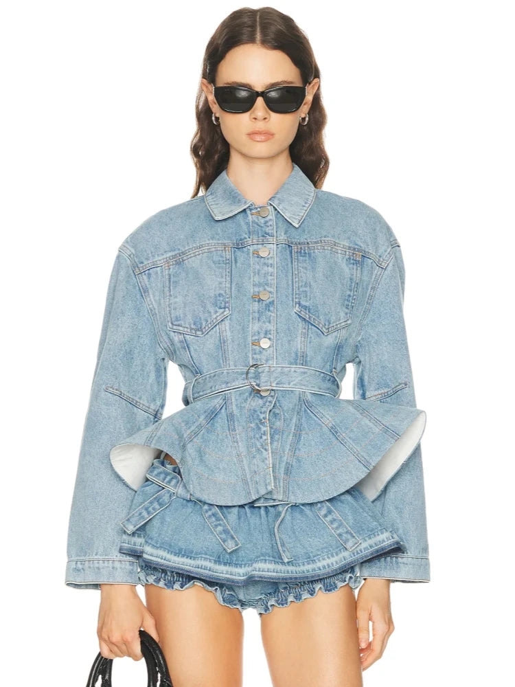 Model wearing a denim peplum jacket with belt and ruched shorts