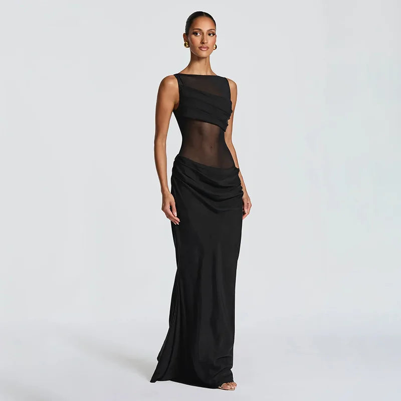 Black evening gown with sheer panels on a white background