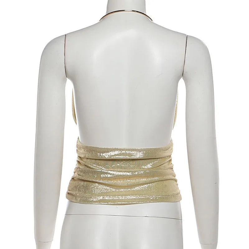 Mannequin wearing a gold metallic top on a white background