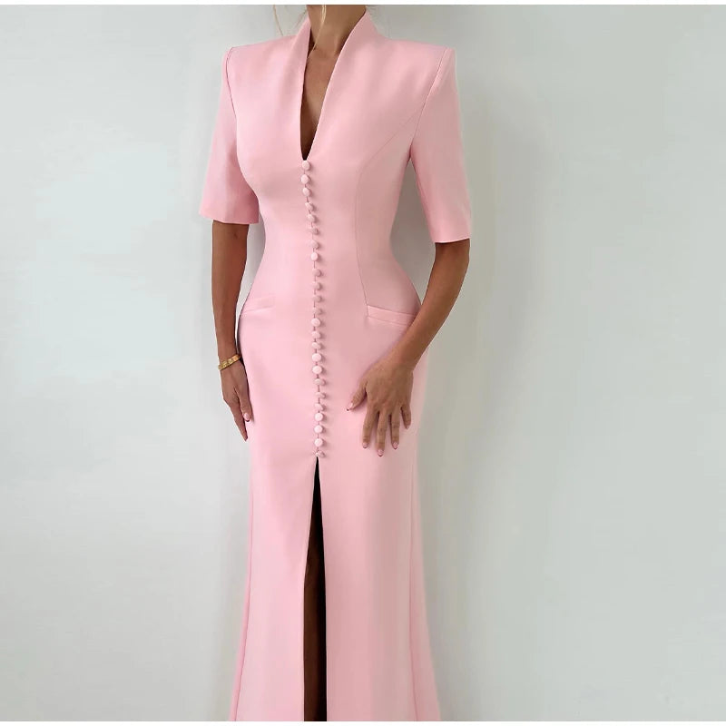 Pink dress with a front slit on a plain background