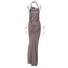 Long brown dress with sheer panels on a white background
