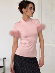 Pink mock neck feather trim top