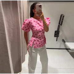 Pink polka dot puff sleeve peplum top side view
