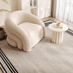 Frosted fleece armchair with cozy round silhouette for reading corner
