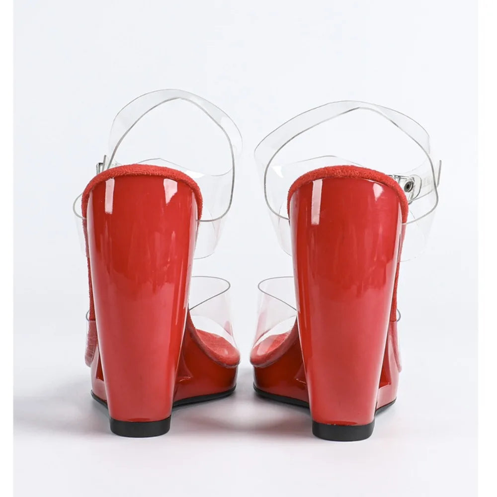 Red high-heeled shoes with clear straps on a white background