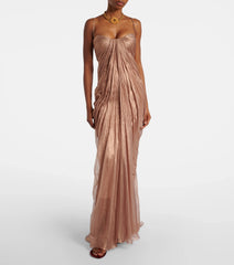 Model wearing a floor-length ruched spaghetti strap evening gown with gold necklace.