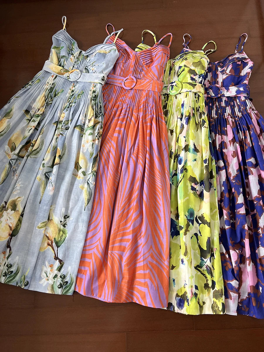 Four floral-patterned dresses hanging on a brown background
