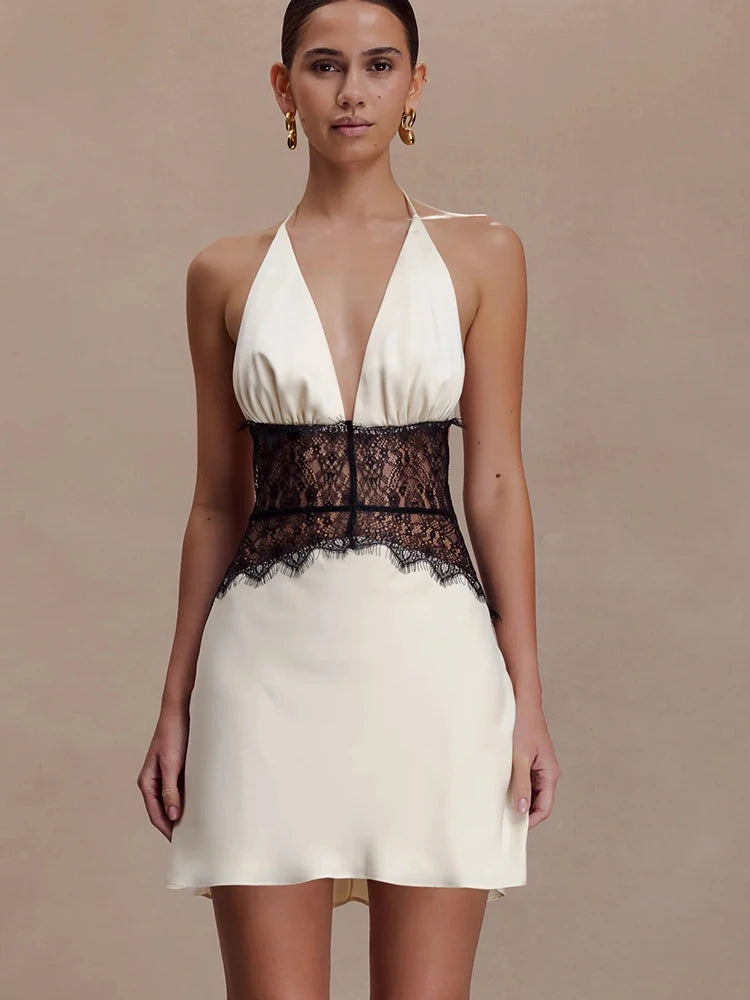 Back view of white halter neck mini dress with lace waist