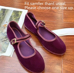 Purple velvet Mary Jane flats with a gold buckle strap.