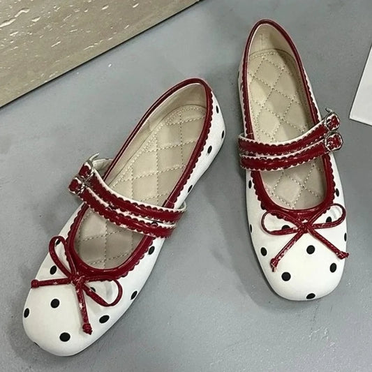 White polka dot ballet flats with red trim and bow