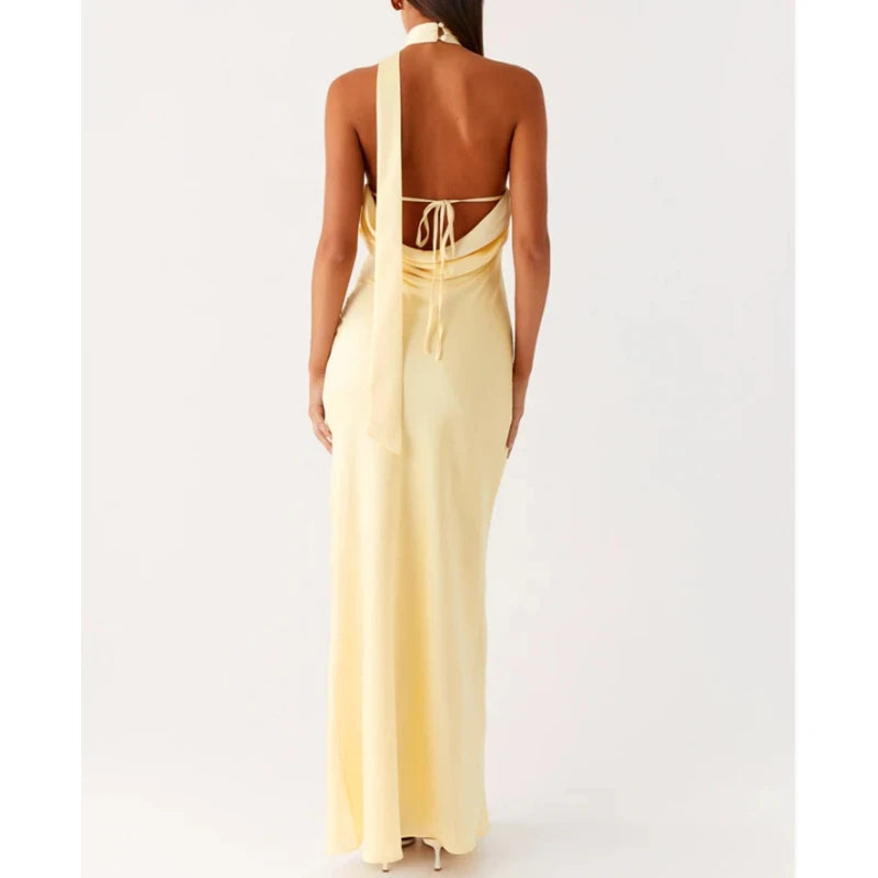 Yellow evening gown with cut-out back design on a white background