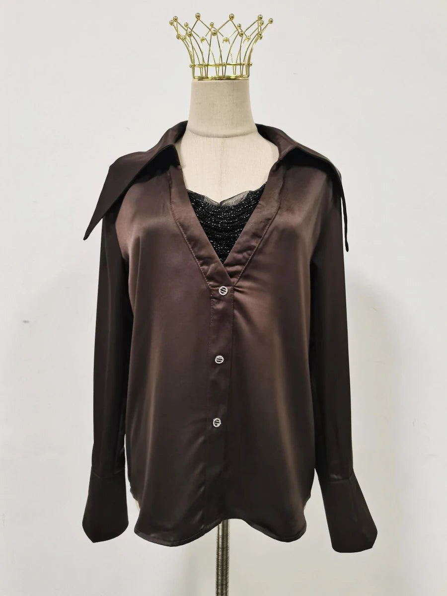 Brown satin shirt on a mannequin with a plain background