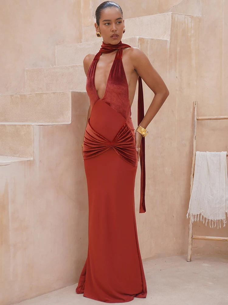 Woman wearing a red evening gown in a neutral setting