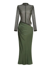 Green dress with sheer long sleeves on a white background