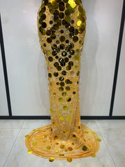Gold sequin dress on a mannequin against a white background