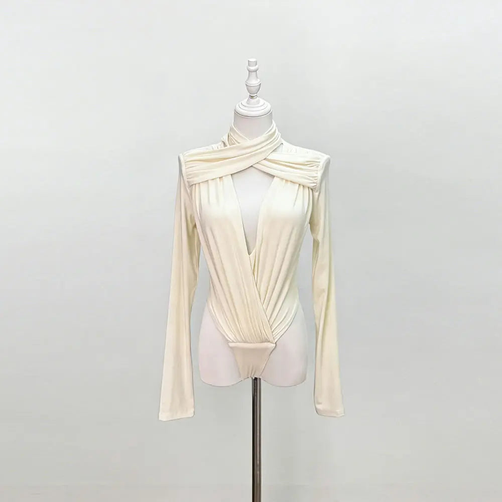 An apricot long-sleeve top on a mannequin against a plain background