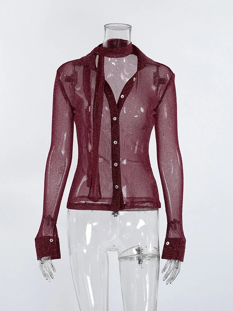 Sheer burgundy blouse on a mannequin against a white background