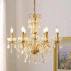 Retro brass chandelier with crystal accents and candle-style lights, illuminating a luxurious dining room. Golden Atelier 4