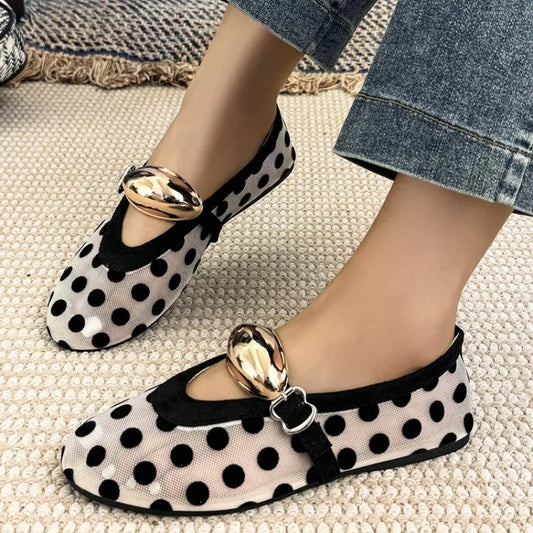Close-up of a polka dot mesh ballet flat showing the texture and buckle.