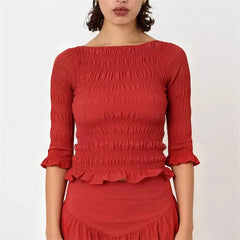 Smocked 3/4 sleeve peplum top in red.