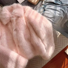 Women’s pink shaggy faux fur coat with turn-down lapel and full sleeves.