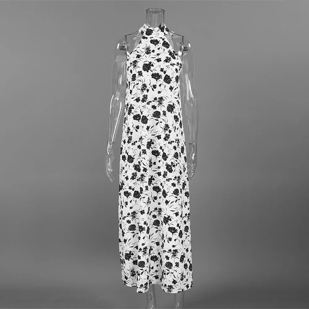 White dress with black floral pattern on a mannequin against a gray background