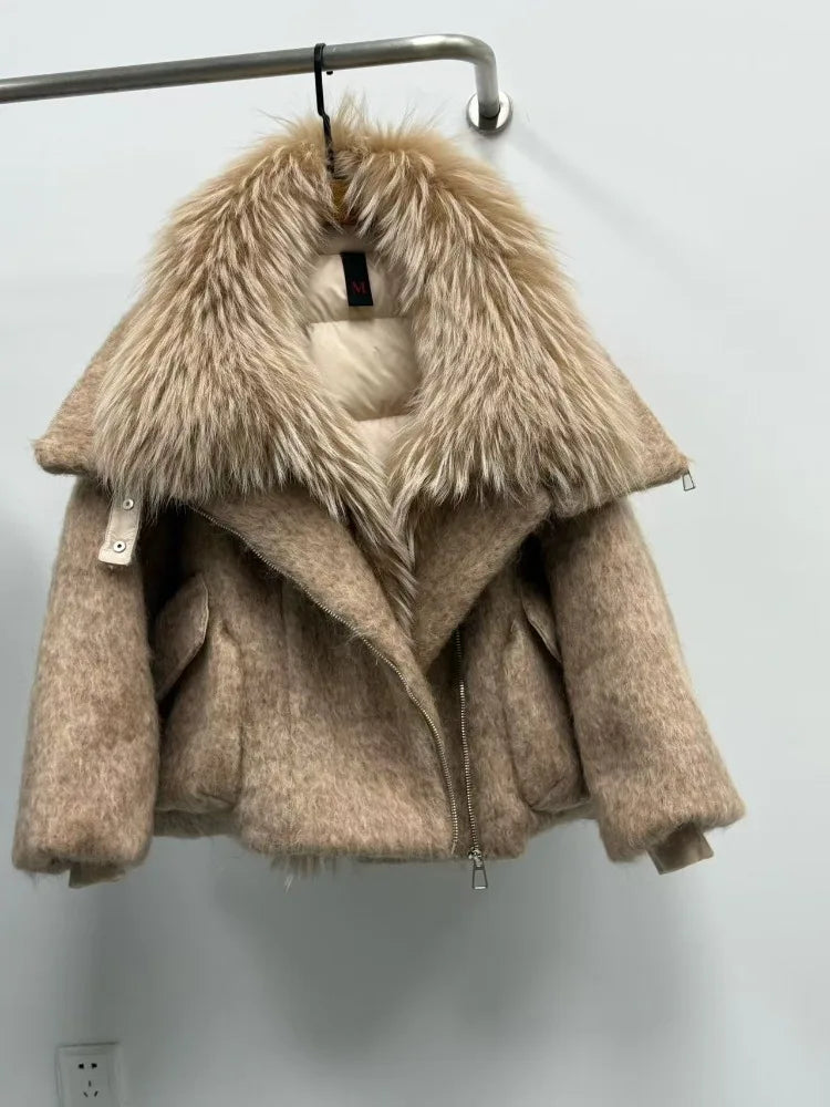 Beige coat with fur collar on a hanger against a white wall
