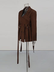 Brown coat on a mannequin against a plain background