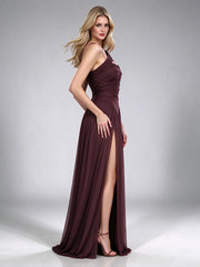 Model wearing a brown one-shoulder draped formal gown with a high leg slit.