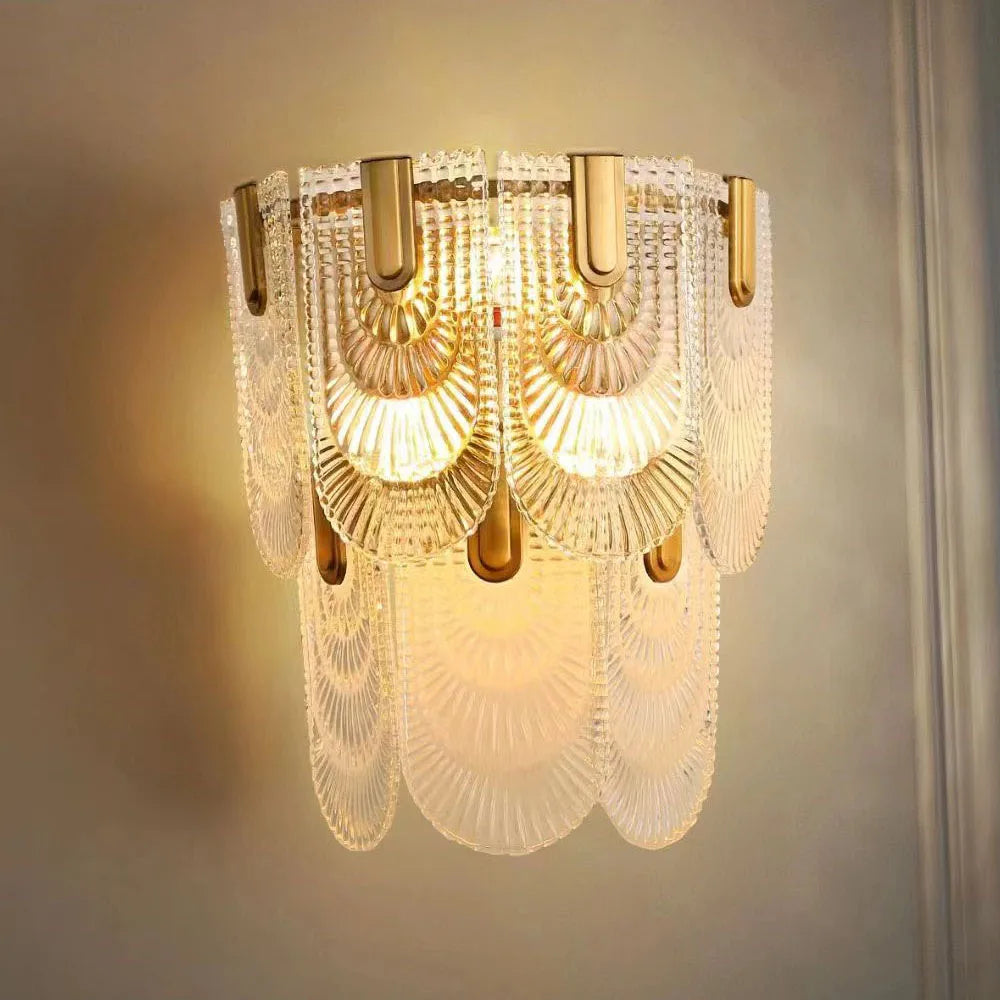 Gold and frosted glass shell wall lamp with decorative layers, softly illuminating elegant bedroom wall