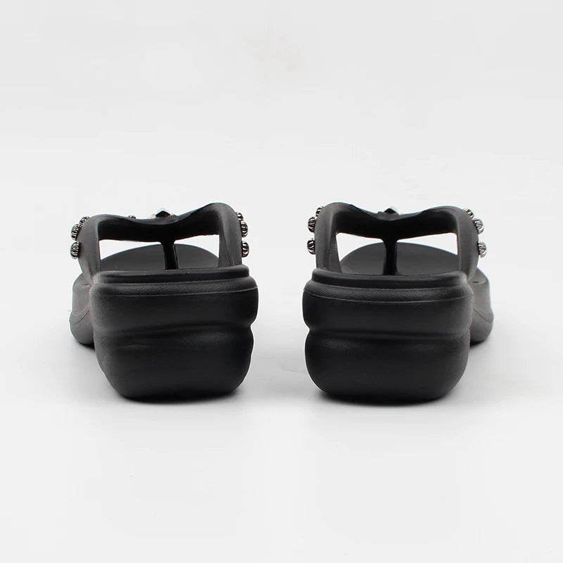 Back view of black platform thong sandals showing the thick platform sole.
